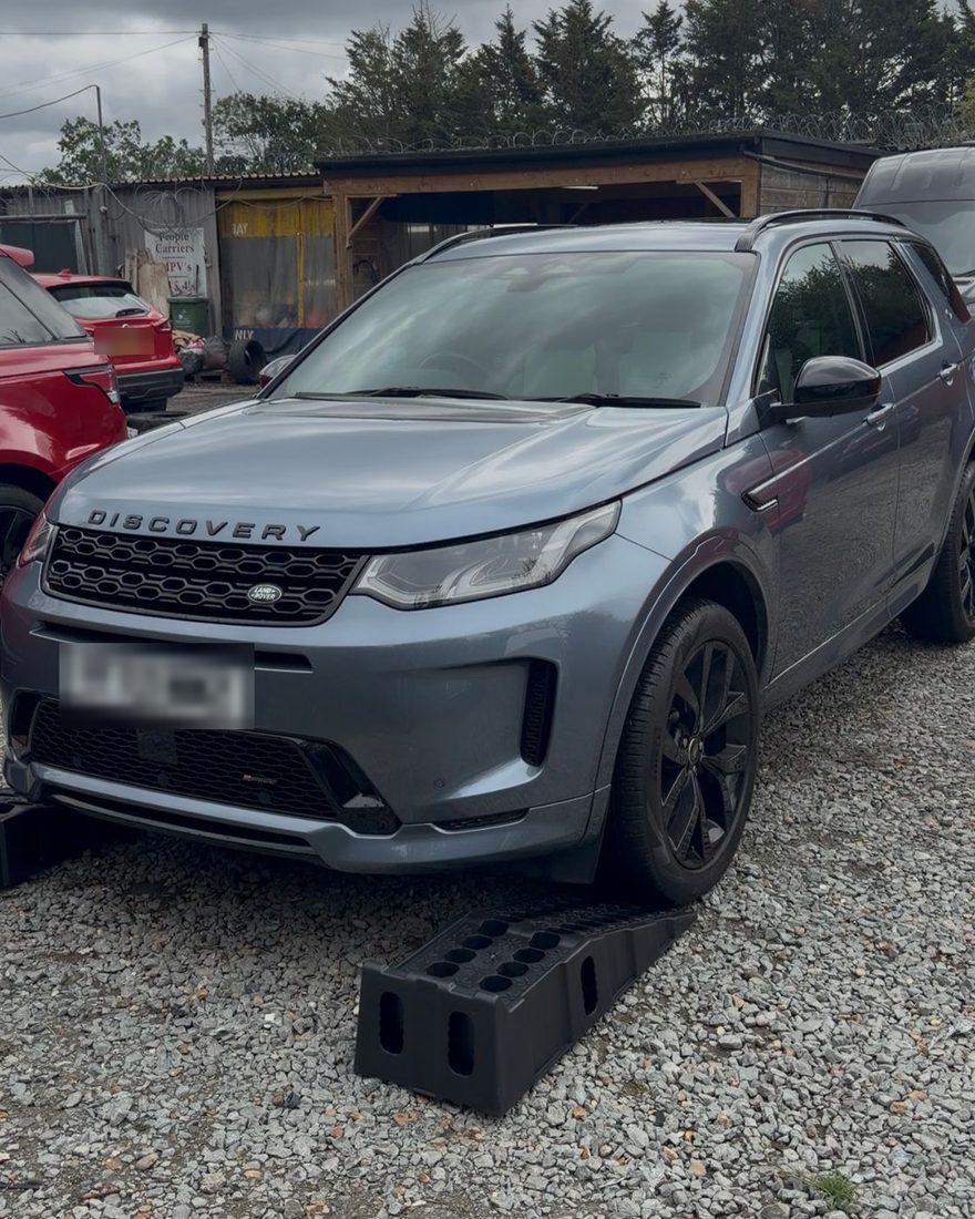 Dave's Land Rover Discovery on ramps during its Premium pre-purchase inspection at a prestige car dealer in Wickford, Essex